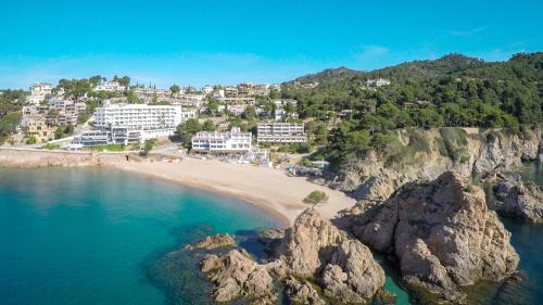 an aerial view of a beach with rocks and houses at Golden Mar Menuda in Tossa de Mar