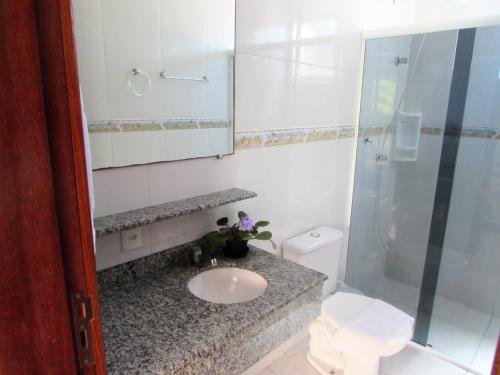 a bathroom with a sink and a shower at Pousada Barra Nativa in Florianópolis