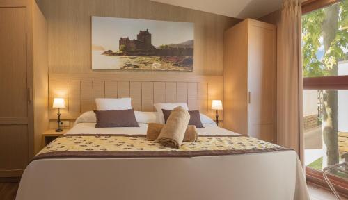 a bedroom with a large bed with two pillows at Magic Robin Hood in Albir