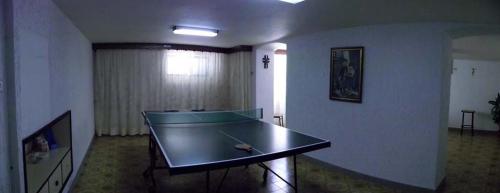 a ping pong table in the middle of a room at Hotel Gianna in Roseto degli Abruzzi