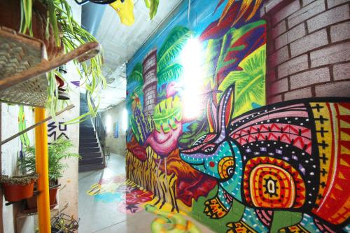 a wall with a colorful painting on it at Brick Palma - Turismo de Interior in Palma de Mallorca
