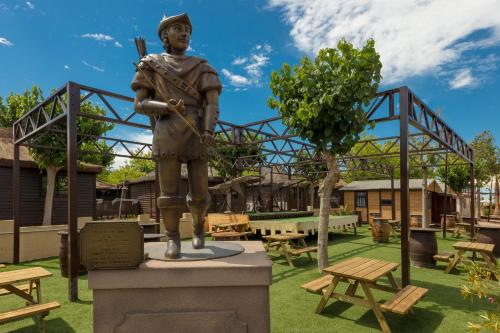 a statue of a man standing in a park at Magic Robin Hood in Albir