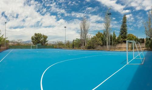 an empty tennis court with a goal on it at Magic Robin Hood in Albir