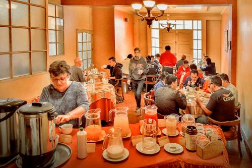 a group of people sitting at tables in a restaurant at Hotel Monserrat in Cochabamba