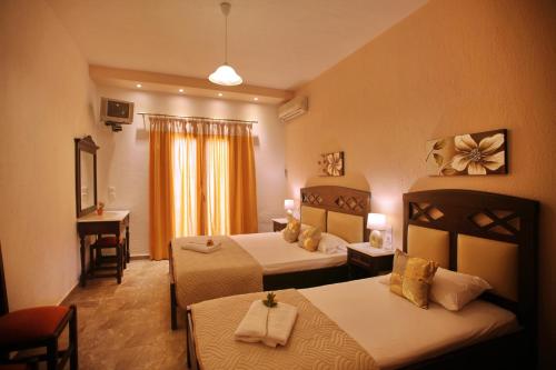 a hotel room with two beds and a window at Maria Studios in Neo Klima