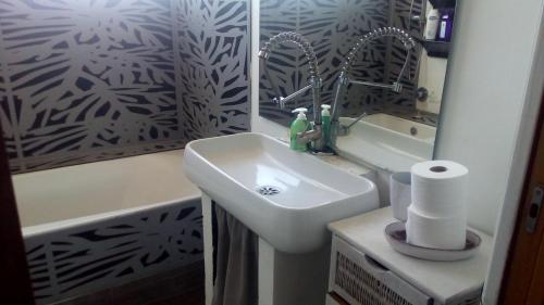 a bathroom with a sink and a mirror at Creative Apartment in Catania