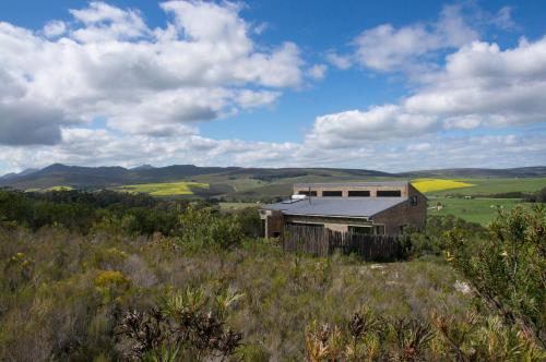 a house on top of a hill in a field at Phillipskop Mountain Reserve in Stanford