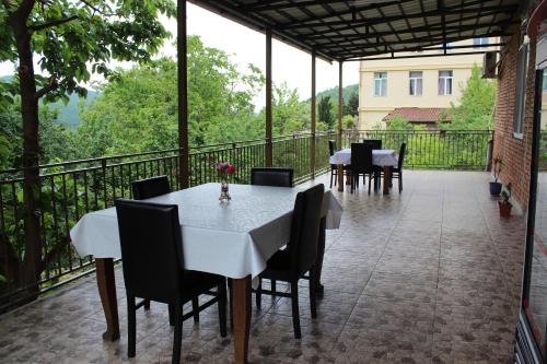 a patio with tables and chairs on a balcony at Elegance in Sighnaghi