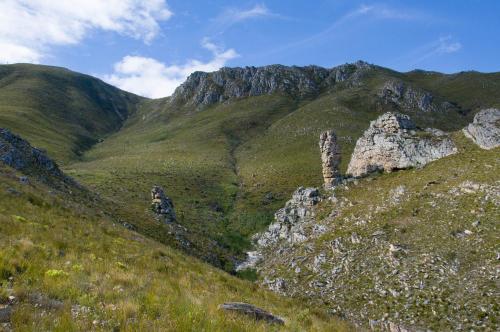 a mountain with rocks on a grassy hill at Phillipskop Mountain Reserve in Stanford