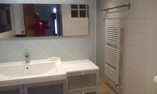 a bathroom with a white sink and a mirror at Casa Trillo Apartamentos in Torres del Obispo