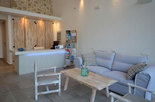a living room with a couch and a table at Kathara Bay Apartments in Faliraki