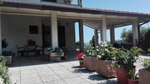 a patio with potted plants and a table in a building at B&B RIPALTA in Sogliano al Rubicone