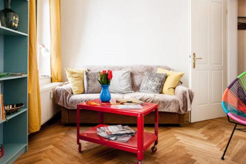 a living room with a couch and a red table at Enjoy Leipzig in Leipzig