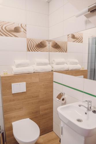 a bathroom with a toilet and a sink at Hotel Duet in Człuchów