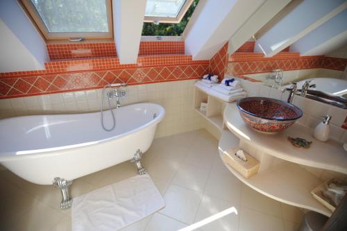a bathroom with a large tub and a sink at Ekosamotnia in Kraków