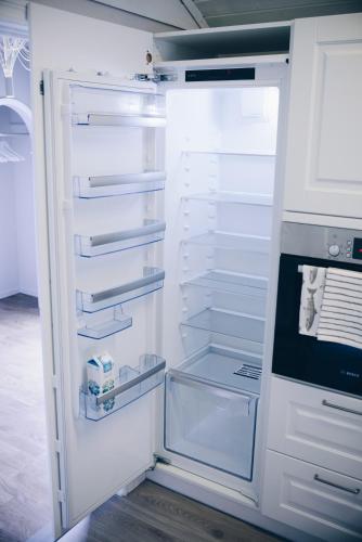 an empty refrigerator with its door open in a kitchen at Dalhus - House with jacuzzi in Norddal