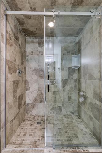 a shower with a glass door in a bathroom at West Wing at Park Town in Saskatoon