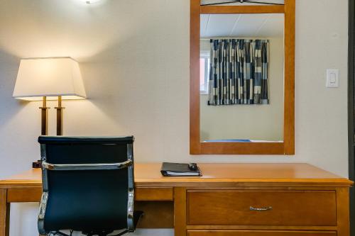 a desk with a chair and a mirror at West Wing at Park Town in Saskatoon