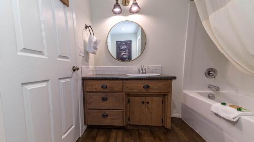 a bathroom with a sink and a mirror at Eagle Cap Chalets in Joseph