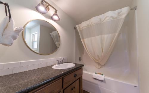 a bathroom with a sink and a mirror at Eagle Cap Chalets in Joseph