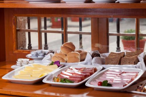 a table topped with trays of food on a table at Hotel Casona Solar in Arequipa