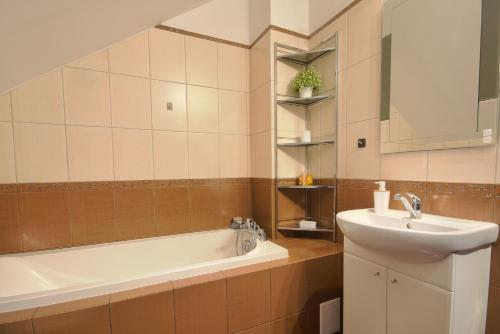 a bathroom with a sink and a bath tub at Apartament SunForYou 1 in Gdańsk