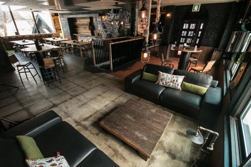an overhead view of a living room with a couch and tables at Hotel Villa Hakuba by HHG in Hakuba