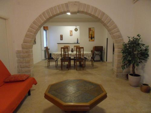 a living room with an archway and a table and chairs at Blasco in Krnica