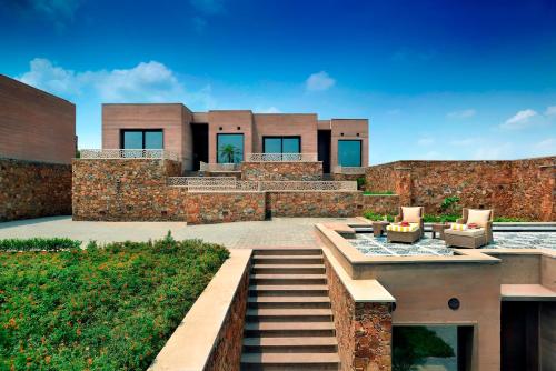 a house with a staircase leading up to it at The Lalit Mangar in Faridabad
