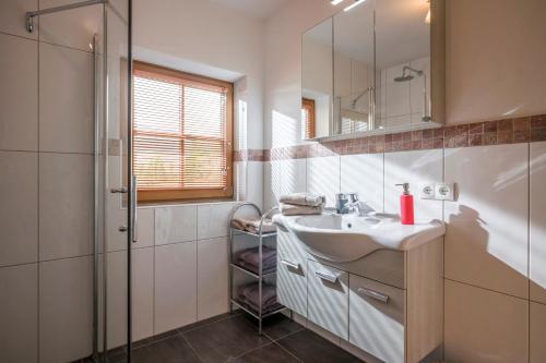 a bathroom with a sink and a shower at Ferienhof Formegg in Hopfgarten im Brixental