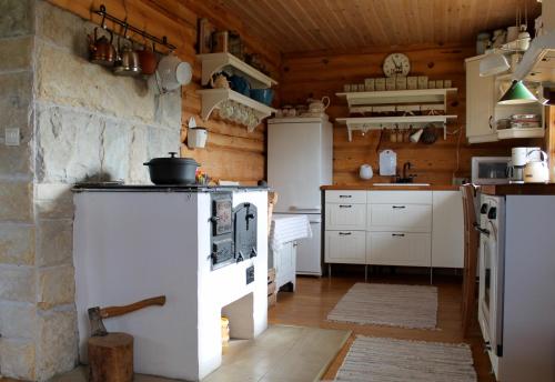 a kitchen with a white stove in a room at Toominga Seaside Cottage in Kõiguste