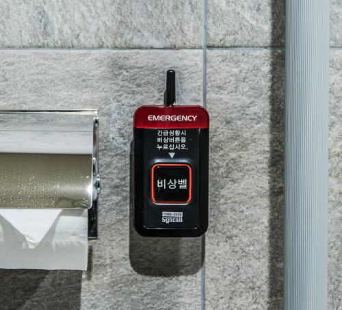 a smart watch is attached to a wall at Rivertain Hotel in Daegu
