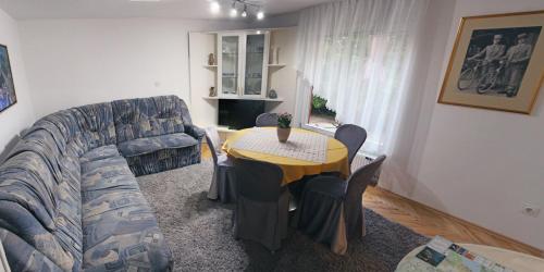 a living room with a couch and a table at Apartma AS in Lesce