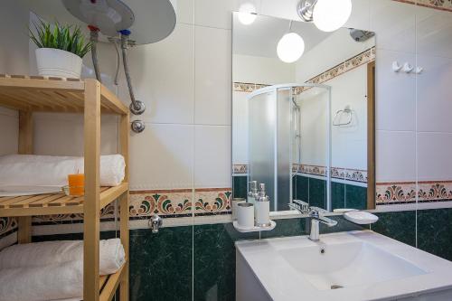 a bathroom with a sink and a bunk bed at Apartments Bo in Malinska