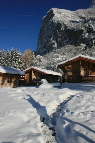 a pile of snow in front of two buildings at Le Relais Du Mont Blanc in Magland