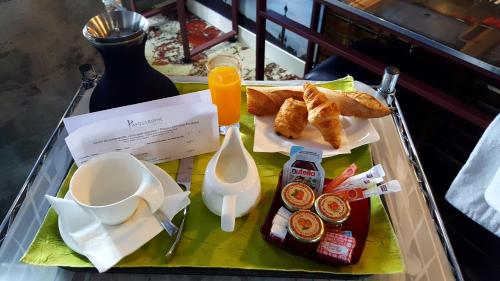 a tray of breakfast food on a table at Apostrophe Hôtel in Paris