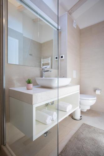 a bathroom with a sink and a toilet at Bova Luxury Rooms in Dubrovnik