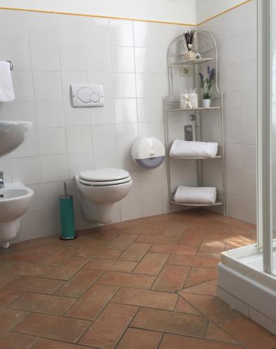 a bathroom with a toilet and a sink at Appartamenti Il Criollo in San Gimignano