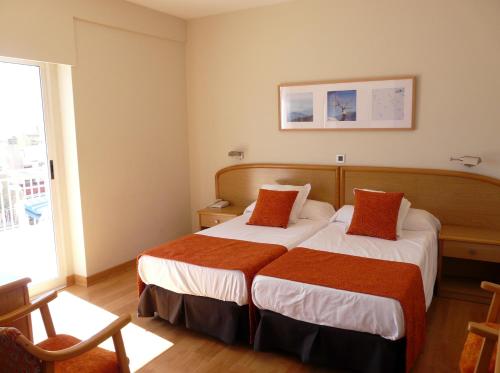 Postel nebo postele na pokoji v ubytování Hotel Tanit