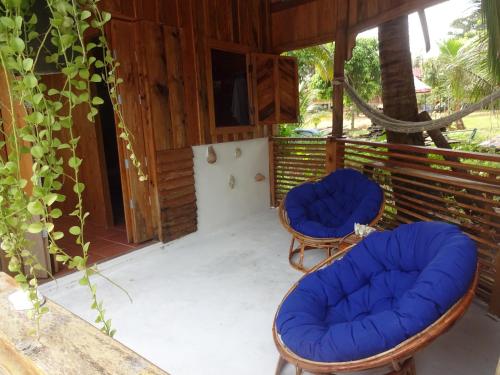 a porch with two chairs and a table at Beach House Cambodia in Koh Rong Sanloem