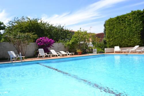 a large swimming pool with lounge chairs at Hotel Amandi in O Grove