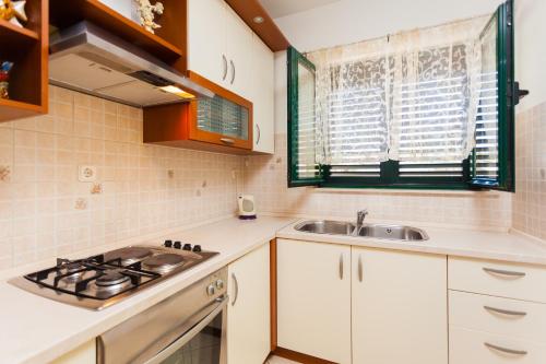 a kitchen with a sink and a stove at Apartments Marija in Vela Luka