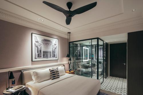 a bedroom with a bed and a ceiling fan at Grand Park City Hall in Singapore