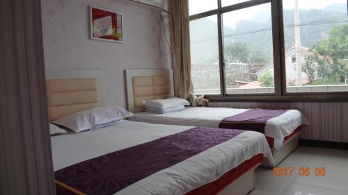 Postel nebo postele na pokoji v ubytování Huangyaguan Great Wall Li Bo Home Hotel