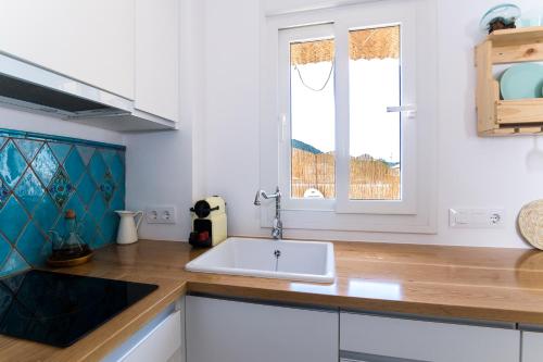 cocina con fregadero blanco y ventana en Ático Junto al Mar en Los Caños de Meca