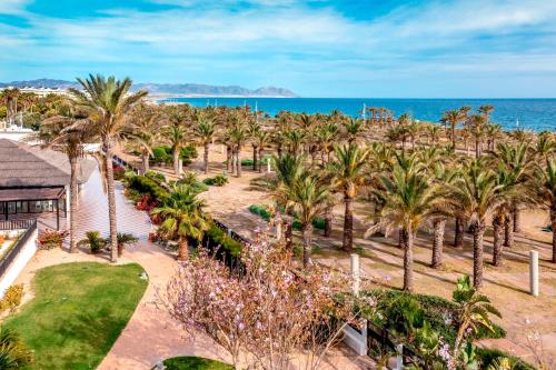an aerial view of a resort with palm trees and the ocean at Barceló Cabo de Gata in Retamar
