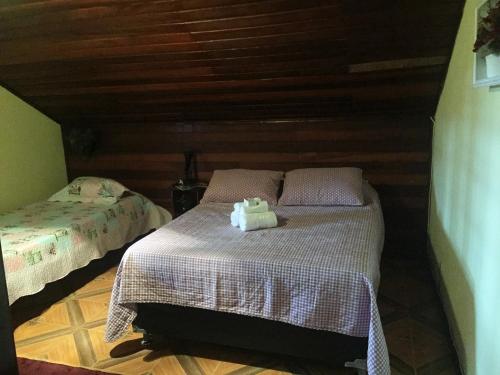 Ένα ή περισσότερα κρεβάτια σε δωμάτιο στο Cama e Café Hospedagem do Bosque