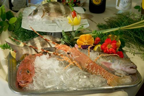 a tray of food with fish on a table at Hotel La Rondine in Sirmione