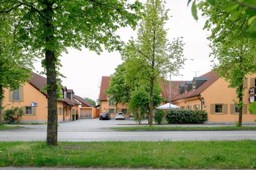 a street in a village with houses and trees at sleepIN in Ingolstadt
