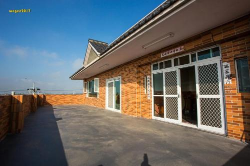 a brick building with a parking lot in front of it at manor in Houli
